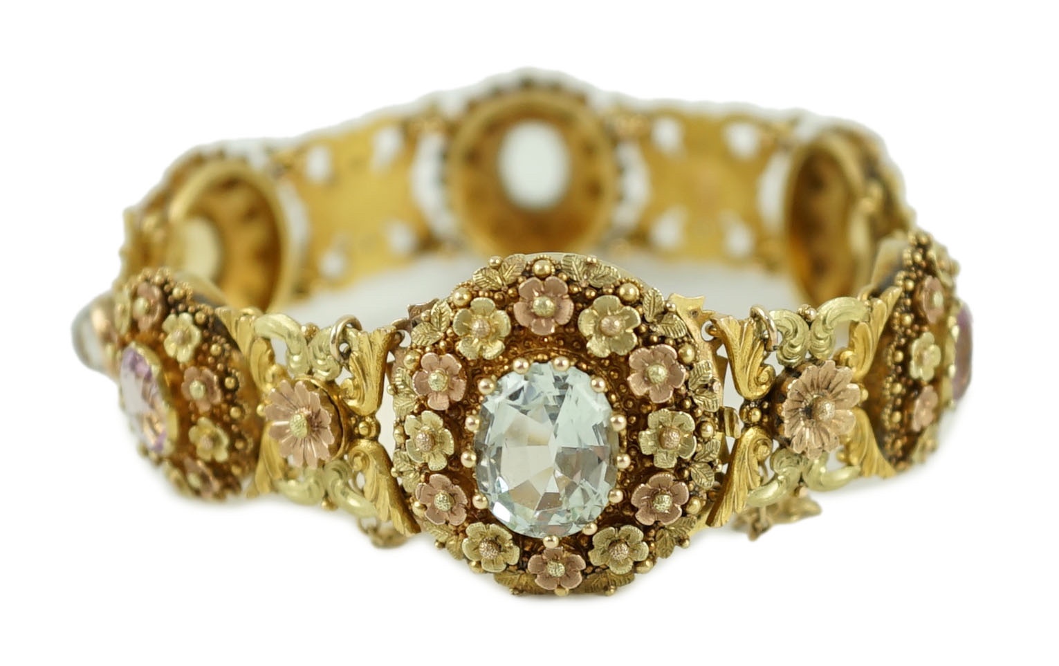 A 19th century pierced three colour gold, pink topaz, moonstone, citrine and aquamarine set bracelet.